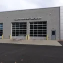 The outdoor of a building with commercial doors with a sign that reads, "Commercial Vehicles."