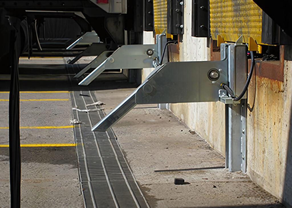 Hydraulic truck restraint mounted beside a loading dock