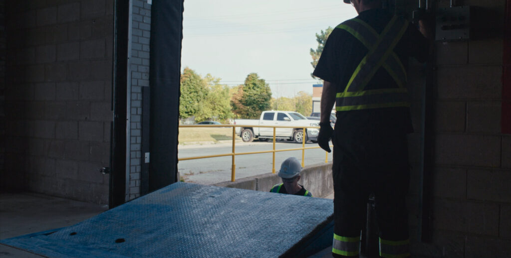 Wilcox team member working near an open loading dock with truck in background