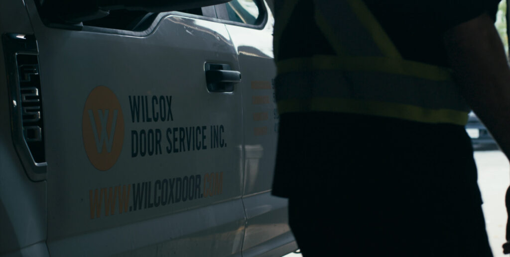 Wilcox Door Service branded truck parked at commercial service site