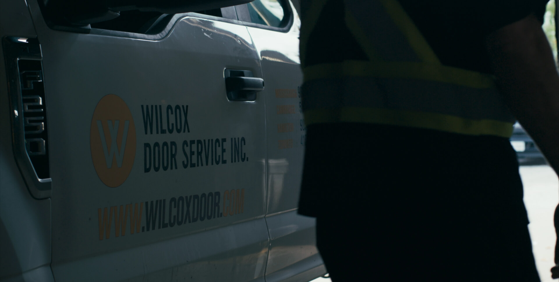Wilcox Door Service branded truck parked at commercial service site