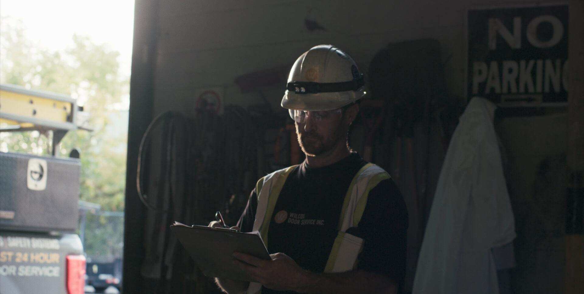 wilcox technician conducting safety inspection inside service garage