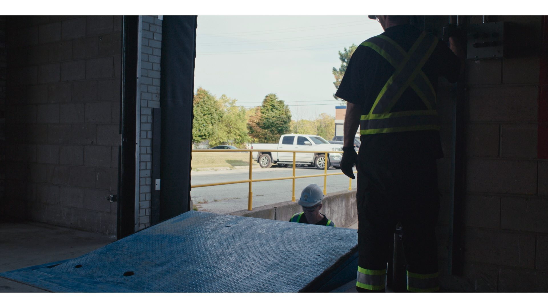 A technician performing commercial door repairs.