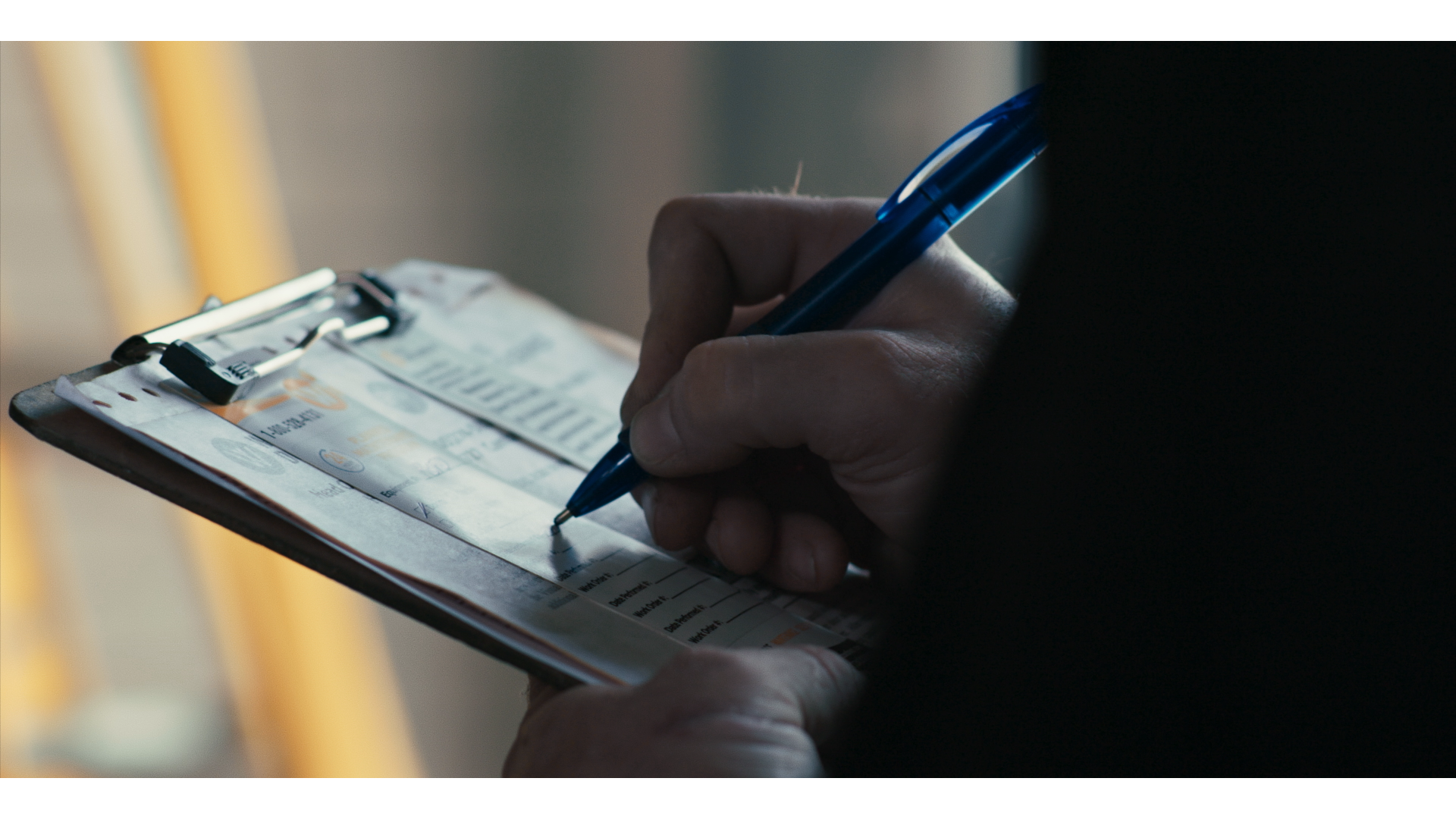 Technician completing a service checklist on a clipboard