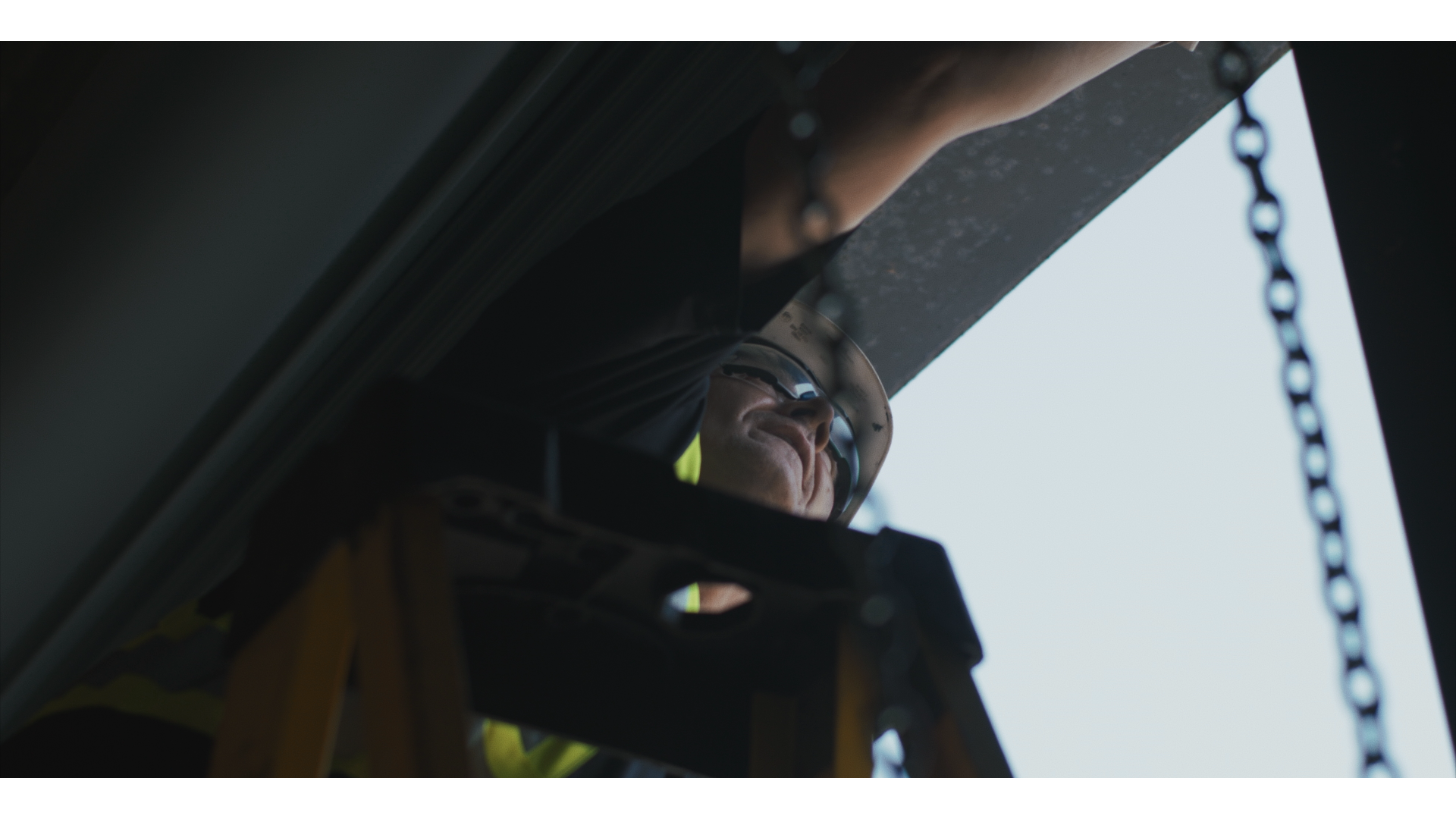 Technician inspecting a door hoist chain